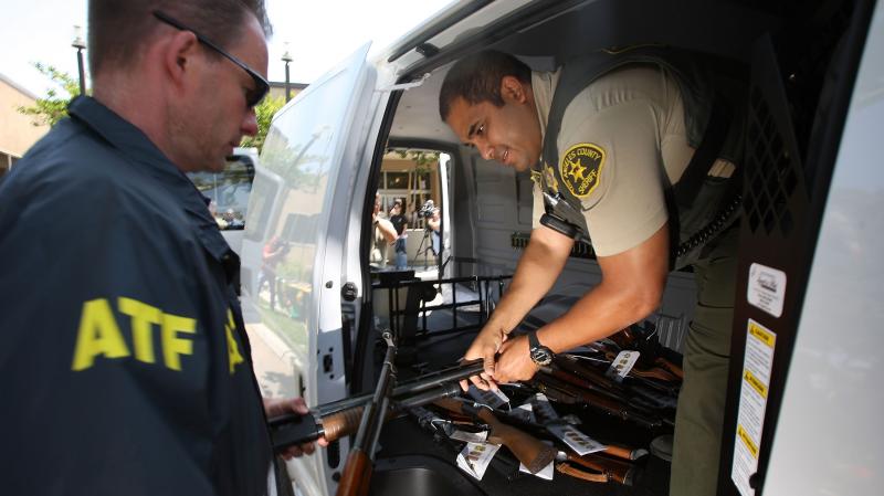 Officers transfer confiscated weapons after a news conference to announce the arrests of scores of alleged gang members and associates on federal racketeering and drug-trafficking charges in Lakewood, Calif., in 2009. Officers transfer confiscated weapons after a news conference to announce the arrests of scores of alleged gang members and associates on federal racketeering and drug-trafficking charges in Lakewood, Calif., in 2009.