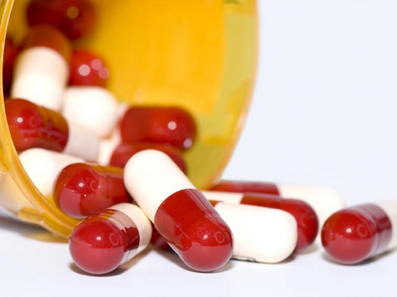 Oxycodone pills spill out of a pillbox Oxycodone pills spill out of a pillbox