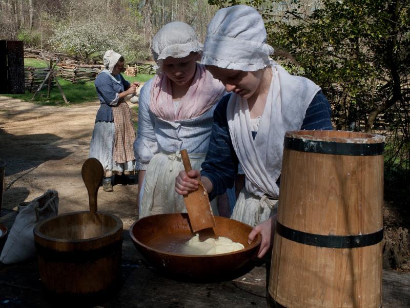 Emma Dodd and Claire Quinn, churn butter at Claude Moore Colonial Farm. Emma Dodd and Claire Quinn, churn butter at Claude Moore Colonial Farm.