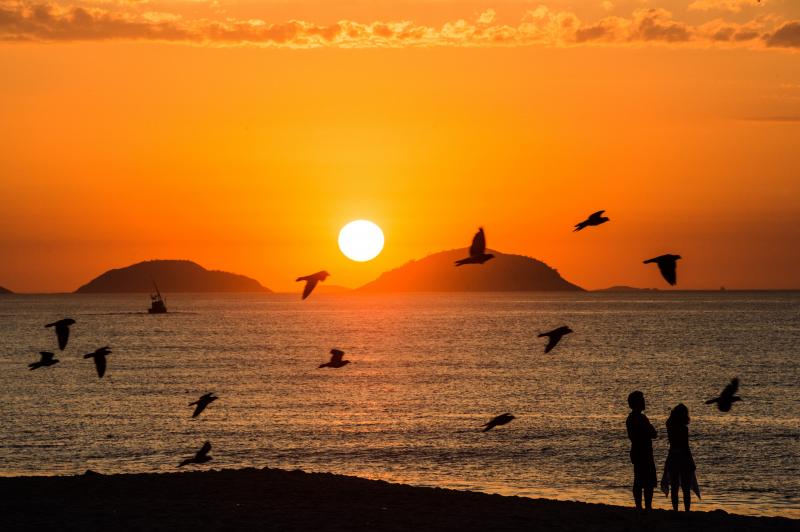 A couple watch the sunrise at Copacabana beach in Rio de Janeiro, Brazil, on Februrary 26, 2013. A couple watch the sunrise at Copacabana beach in Rio de Janeiro, Brazil, on Februrary 26, 2013.