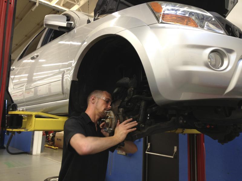 C.J. Forza, a student in the I-BEST program in Washington state, repairs a car for class at Shoreline Community College. C.J. Forza, a student in the I-BEST program in Washington state, repairs a car for class at Shoreline Community College.