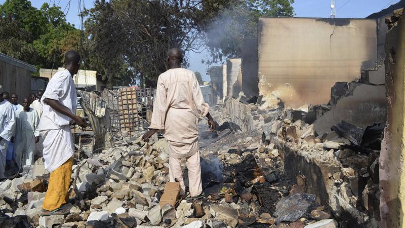 Men walk amid rubble after Boko Haram militants raided the town of Benisheik in northeast Nigeria, on Sept. 19. The Islamist group has been waging an insurgency in northern and central Nigeria for the past four years and was recently placed on the U.S. li Men walk amid rubble after Boko Haram militants raided the town of Benisheik in northeast Nigeria, on Sept. 19. The Islamist group has been waging an insurgency in northern and central Nigeria for the past four years and was recently placed on the U.S. li