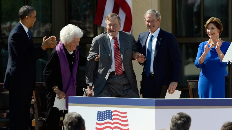 President Obama applauds as former first lady Barbara Bush and former President George W. Bush help President George H.W. Bush stand at the opening ceremony of the George W. Bush Presidential Library on April 25 in Dallas. Former first lady Laura Bush loo President Obama applauds as former first lady Barbara Bush and former President George W. Bush help President George H.W. Bush stand at the opening ceremony of the George W. Bush Presidential Library on April 25 in Dallas. Former first lady Laura Bush loo