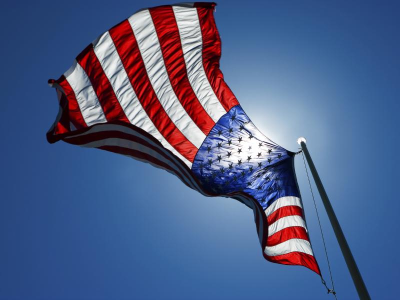 An American flag waves in the sky. An American flag waves in the sky.