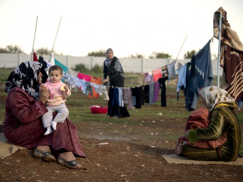 Mothers and their children sit among their washing in a refugee camp on the border between Syria and Turkey near the northern city of Azaz on Wednesday. The internally displaced faced further misery as heavy rain was followed by a drop in temperatures. Mothers and their children sit among their washing in a refugee camp on the border between Syria and Turkey near the northern city of Azaz on Wednesday. The internally displaced faced further misery as heavy rain was followed by a drop in temperatures.