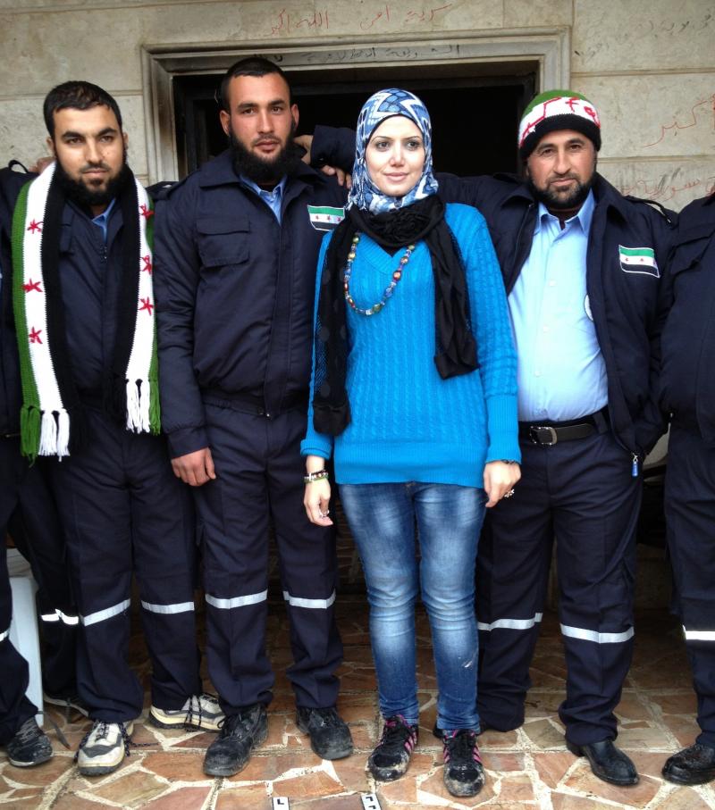Razan Shalab Al-Sham, in bright blue, works for the Syrian Emergency Task Force. She helped provide uniforms for the new civil police force of Khirbet al-Joz in northern Syria. Razan Shalab Al-Sham, in bright blue, works for the Syrian Emergency Task Force. She helped provide uniforms for the new civil police force of Khirbet al-Joz in northern Syria.