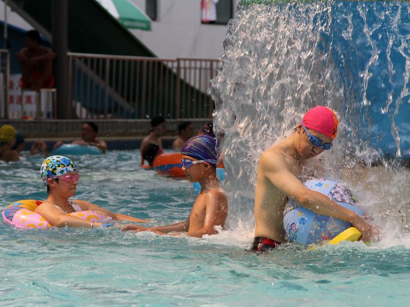 People cool off Wednesday in a pool in Shanghai, where temperatures reached an all-time record: 105.4 degrees. People cool off Wednesday in a pool in Shanghai, where temperatures reached an all-time record: 105.4 degrees.