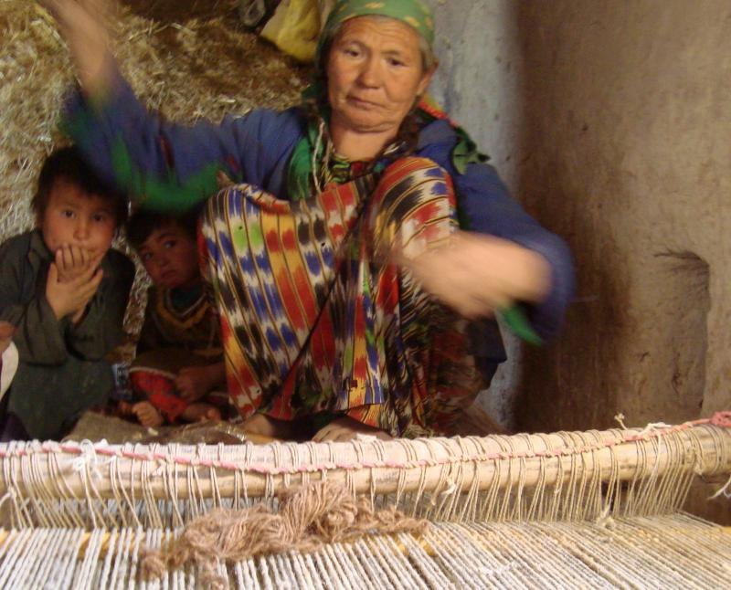 In Oqa, Afghanistan, Boston weaves a saddlebag for her husband's donkey. The weavers of Oqa also weave large carpets, earning less than $1 a day for their work. In Oqa, Afghanistan, Boston weaves a saddlebag for her husband's donkey. The weavers of Oqa also weave large carpets, earning less than $1 a day for their work.