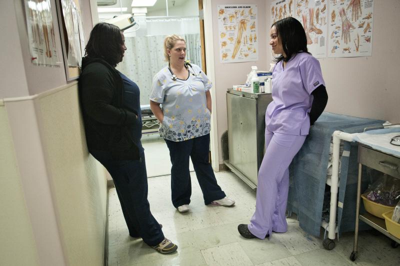 Peggy Renzi (middle) talks with her teammates Erika Hersey (left) and Erica Webster. The three are part of a team of nurses in the Bowie Health Center emergency room in Bowie, Md., who are working together to lose weight. Peggy Renzi (middle) talks with her teammates Erika Hersey (left) and Erica Webster. The three are part of a team of nurses in the Bowie Health Center emergency room in Bowie, Md., who are working together to lose weight.