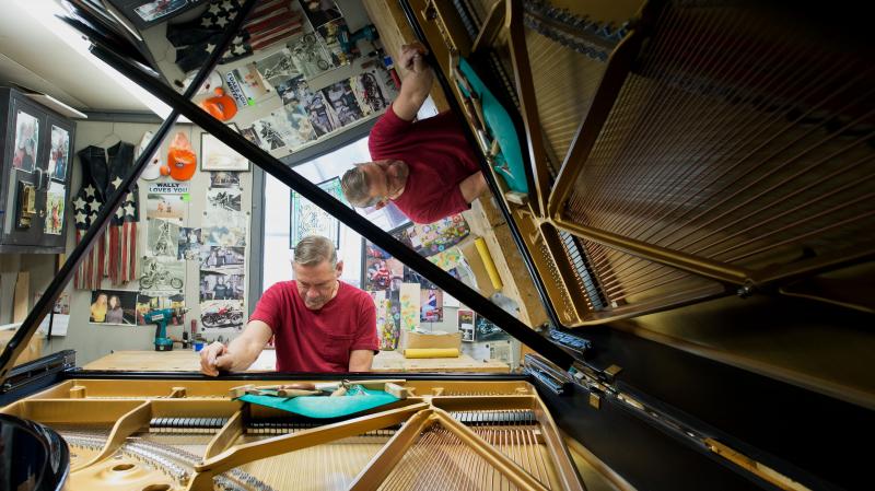 Some Steinway company representatives and employees — like Wally Boot, pictured here — have been working for the company for decades. Boot is the last person to touch every piano that leaves the factory in Queens, N.Y. Some Steinway company representatives and employees — like Wally Boot, pictured here — have been working for the company for decades. Boot is the last person to touch every piano that leaves the factory in Queens, N.Y.