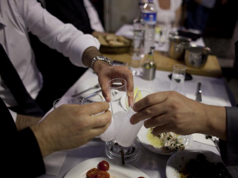 Diners drinking raki, a traditional Turkish alcoholic drink flavored with anise, at a restaurant in Istanbul. Diners drinking raki, a traditional Turkish alcoholic drink flavored with anise, at a restaurant in Istanbul.