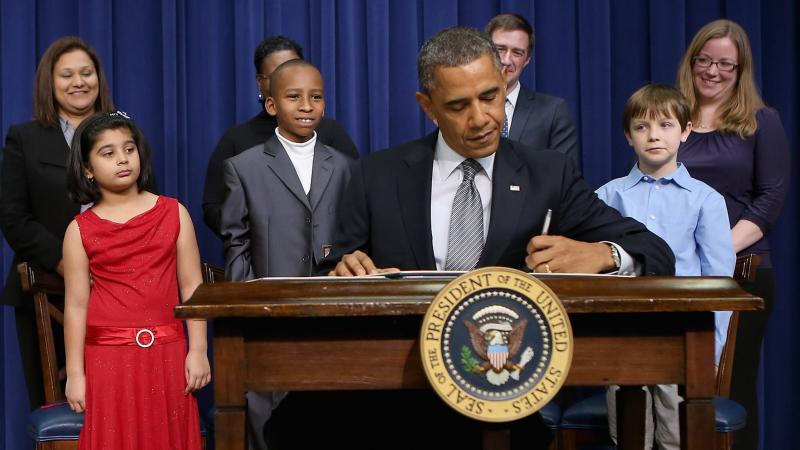 President Obama signs a series of executive orders Wednesday about the administration's gun law proposals as Vice President Biden and children who wrote letters to the White House about gun violence look on. President Obama signs a series of executive orders Wednesday about the administration's gun law proposals as Vice President Biden and children who wrote letters to the White House about gun violence look on.