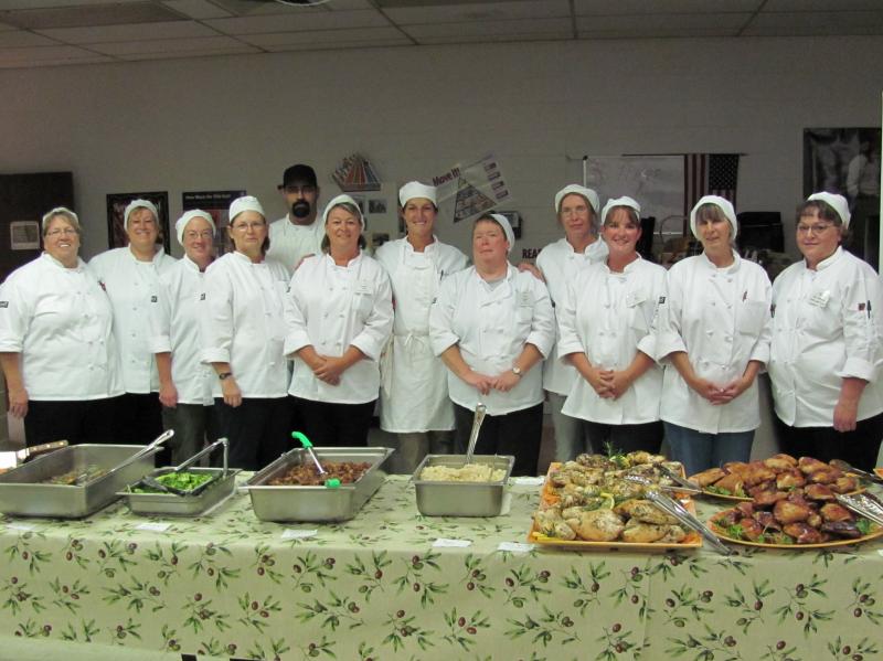 Kathy Del Tonto (far right) participates in a class that teaches school cafeteria workers how to prepare meals from scratch. Kathy Del Tonto (far right) participates in a class that teaches school cafeteria workers how to prepare meals from scratch.