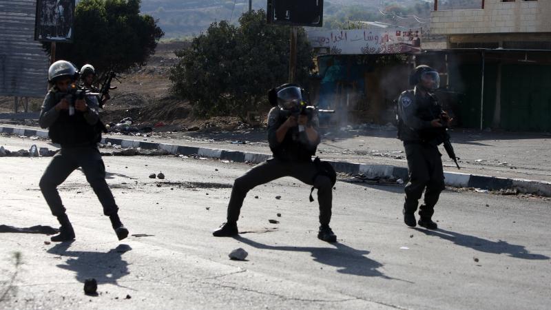 Israeli border guards take aim at Palestinian demonstrators (unseen) during clashes at the Hawara checkpoint, south of the West Bank city of Nablus on Friday. Israeli border guards take aim at Palestinian demonstrators (unseen) during clashes at the Hawara checkpoint, south of the West Bank city of Nablus on Friday.
