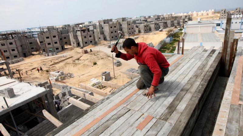 A Palestinian laborer works at the site of a residential construction project funded by the United Nations Relief and Works Agency for Palestine Refugees in Rafah, in the southern Gaza Strip, on Mar. 21, 2012. A Palestinian laborer works at the site of a residential construction project funded by the United Nations Relief and Works Agency for Palestine Refugees in Rafah, in the southern Gaza Strip, on Mar. 21, 2012.