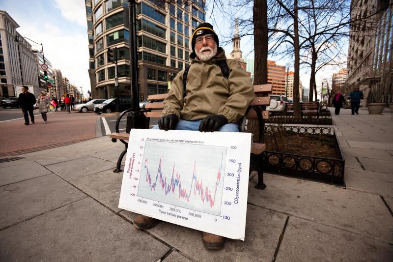 Dr. J. William Hirzy, a chemistry professor at American Universiy, rests outside the rally route with a graph he uses to teach his students about the relationship between atmospheric carbon dioxide and global temperature. Dr. J. William Hirzy, a chemistry professor at American Universiy, rests outside the rally route with a graph he uses to teach his students about the relationship between atmospheric carbon dioxide and global temperature.