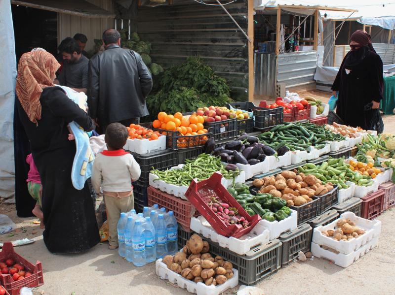 Syrian refugees shop at a makeshift grocery store at the Zaatari camp in March. Syrian refugees shop at a makeshift grocery store at the Zaatari camp in March.