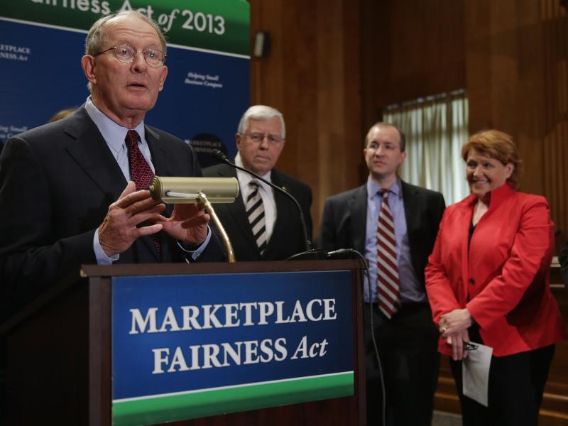 Sen. Lamar Alexander, R-Tenn. (left), leads a news conference about the Marketplace Fairness Act on Tuesday. The legislation would provide states with the authority to require out-of-state retailers to collect and remit taxes on purchases shipped into the Sen. Lamar Alexander, R-Tenn. (left), leads a news conference about the Marketplace Fairness Act on Tuesday. The legislation would provide states with the authority to require out-of-state retailers to collect and remit taxes on purchases shipped into the