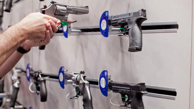 A visitor handles a revolver at a Smith & Wesson display during the NRA Annual Meetings and Exhibits on April 14 at America's Center in St. Louis, Mo. A visitor handles a revolver at a Smith & Wesson display during the NRA Annual Meetings and Exhibits on April 14 at America's Center in St. Louis, Mo.