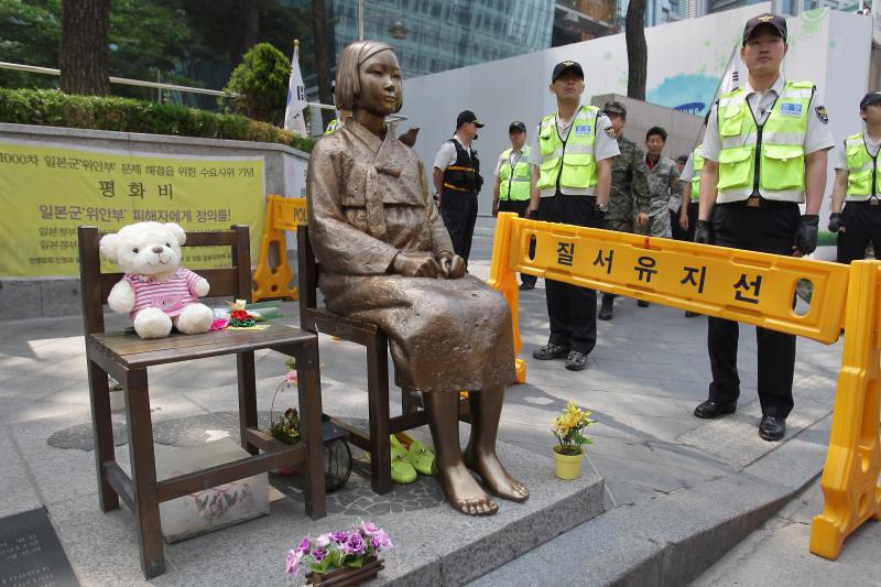 South Korean police stand guard beside a comfort woman statue in front of the Japanese embassy in Seoul in May. The Southern California city of Glendale will dedicate an identical statue on Tuesday. South Korean police stand guard beside a comfort woman statue in front of the Japanese embassy in Seoul in May. The Southern California city of Glendale will dedicate an identical statue on Tuesday.
