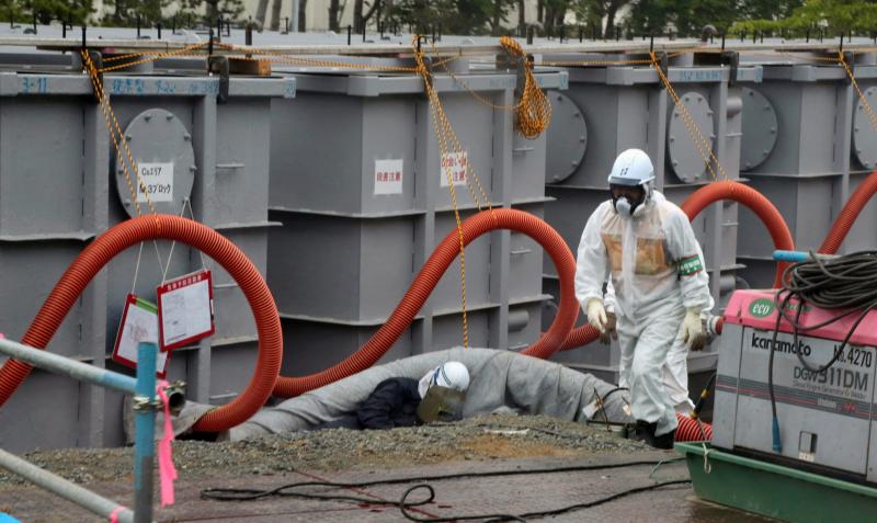 Tokyo Electric Power Co (TEPCO) workers work on waste water tanks at Japan's Fukushima Daiichi nuclear plant in the town of Okuma, Fukushima prefecture in Japan on June 12, 2013. Tokyo Electric Power Co (TEPCO) workers work on waste water tanks at Japan's Fukushima Daiichi nuclear plant in the town of Okuma, Fukushima prefecture in Japan on June 12, 2013.