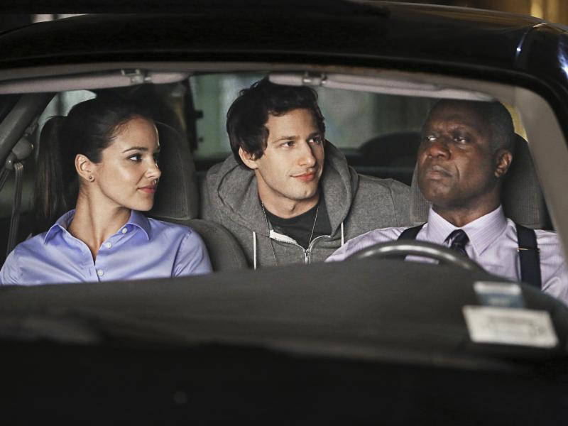 Capt. Ray Holt (Andre Braugher, right) leads detectives Jake Peralta (Andy Samberg) and Amy Santiago (Melissa Fumero) on a police stakeout in Brooklyn Nine-Nine. Capt. Ray Holt (Andre Braugher, right) leads detectives Jake Peralta (Andy Samberg) and Amy Santiago (Melissa Fumero) on a police stakeout in Brooklyn Nine-Nine.