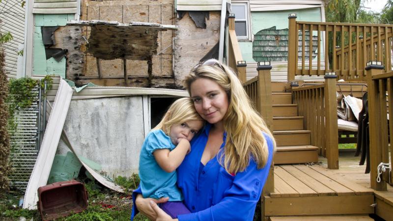 Samantha Langello and her daughter Alanna, 2, stand in front of their flood-damaged house in Fox Beach on Staten Island, N.Y. Samantha Langello and her daughter Alanna, 2, stand in front of their flood-damaged house in Fox Beach on Staten Island, N.Y.