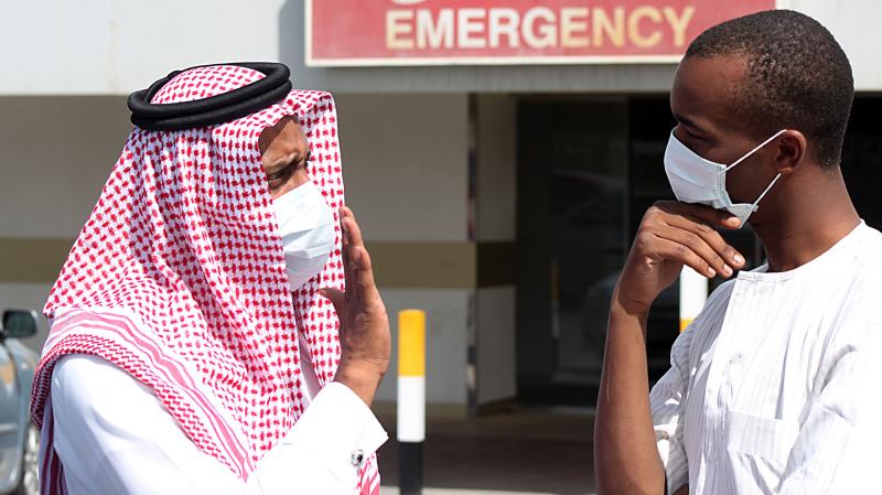Men outside a hospital in Dammam, Saudi Arabia, wear surgical masks as a precaution against infection with a coronavirus. Men outside a hospital in Dammam, Saudi Arabia, wear surgical masks as a precaution against infection with a coronavirus.