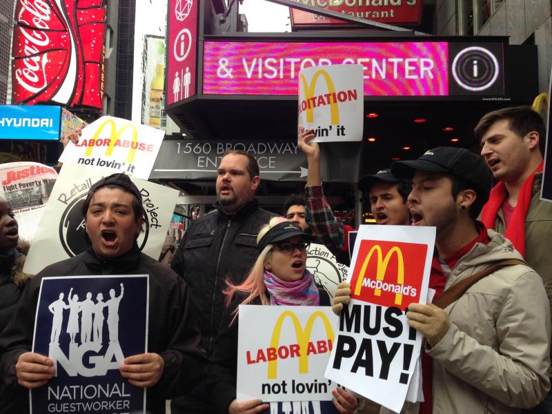 Workers and labor organizers in New York City protest the alleged exploitation of students on J-1 summer work travel visas who worked at a Pennsylvania McDonald's, on Thursday. Workers and labor organizers in New York City protest the alleged exploitation of students on J-1 summer work travel visas who worked at a Pennsylvania McDonald's, on Thursday.