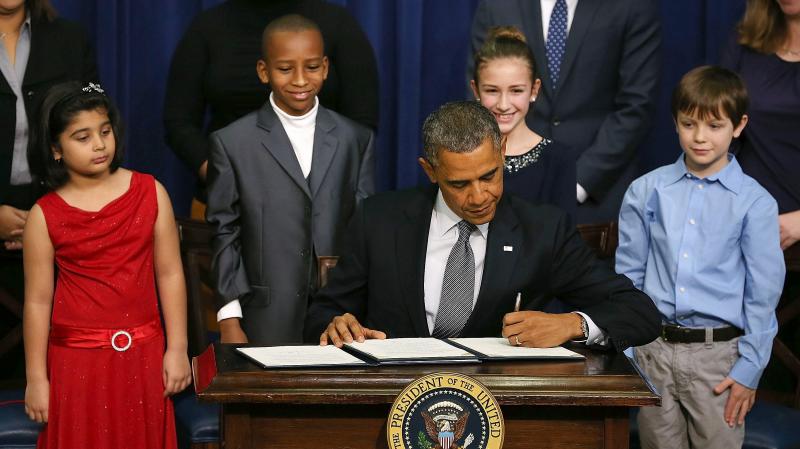 President Obama signs a series of executive orders on gun control Jan. 16 surrounded by children who wrote letters to the White House about gun violence. They are, from left, Hinna Zeejah, Taejah Goode, Julia Stokes and Grant Fritz. President Obama signs a series of executive orders on gun control Jan. 16 surrounded by children who wrote letters to the White House about gun violence. They are, from left, Hinna Zeejah, Taejah Goode, Julia Stokes and Grant Fritz.