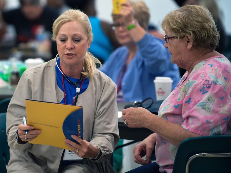 Part of the gains in the U.S. job market last month came in health care, the Bureau of Labor Statistics says. Here, a nurse screens a patient in Emporia, Va. Part of the gains in the U.S. job market last month came in health care, the Bureau of Labor Statistics says. Here, a nurse screens a patient in Emporia, Va.