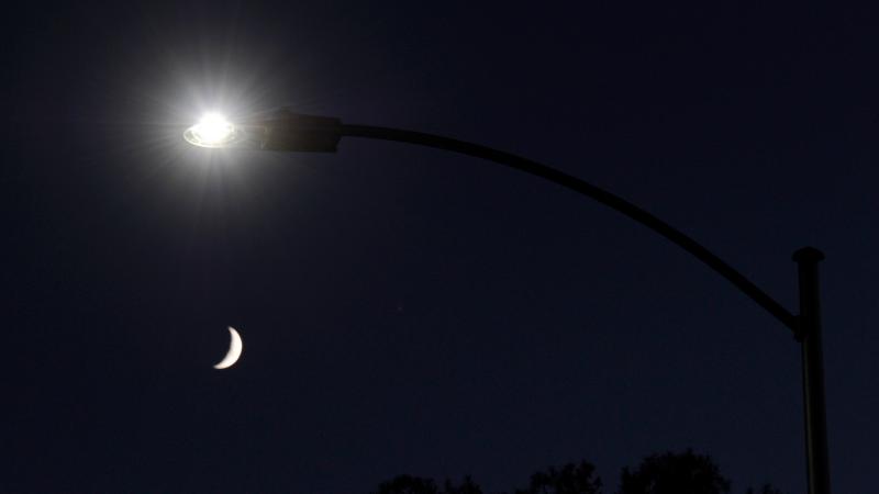 A waxing crescent moon is seen behind a streetlight with a newly installed LED fixture in 2011 in Las Vegas. The city was replacing 6,600 existing lights with the energy-efficient LEDs. It has since replaced tens of thousands more. A waxing crescent moon is seen behind a streetlight with a newly installed LED fixture in 2011 in Las Vegas. The city was replacing 6,600 existing lights with the energy-efficient LEDs. It has since replaced tens of thousands more.
