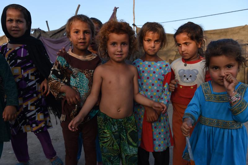 Afghan children look on at a refugee camp in Jalalabad on May 3, 2015. Like thousands of Afghan returnees, Neik Mohammad became unwanted in Pakistan after a Taliban massacre at a Peshawar school, forcing him to return home to a life of misery and fear in Afghan children look on at a refugee camp in Jalalabad on May 3, 2015. Like thousands of Afghan returnees, Neik Mohammad became unwanted in Pakistan after a Taliban massacre at a Peshawar school, forcing him to return home to a life of misery and fear in