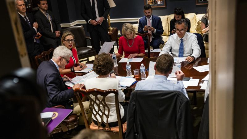 From left: Sens. Bill Cassidy, R-La., Kyrsten Sinema, D-Ariz., Lisa Murkowski, R-Alaska, Mitt Romney, R-Utah, and others hold a bipartisan meeting on infrastructure in the basement of the U.S. Capitol on Tuesday. From left: Sens. Bill Cassidy, R-La., Kyrsten Sinema, D-Ariz., Lisa Murkowski, R-Alaska, Mitt Romney, R-Utah, and others hold a bipartisan meeting on infrastructure in the basement of the U.S. Capitol on Tuesday.