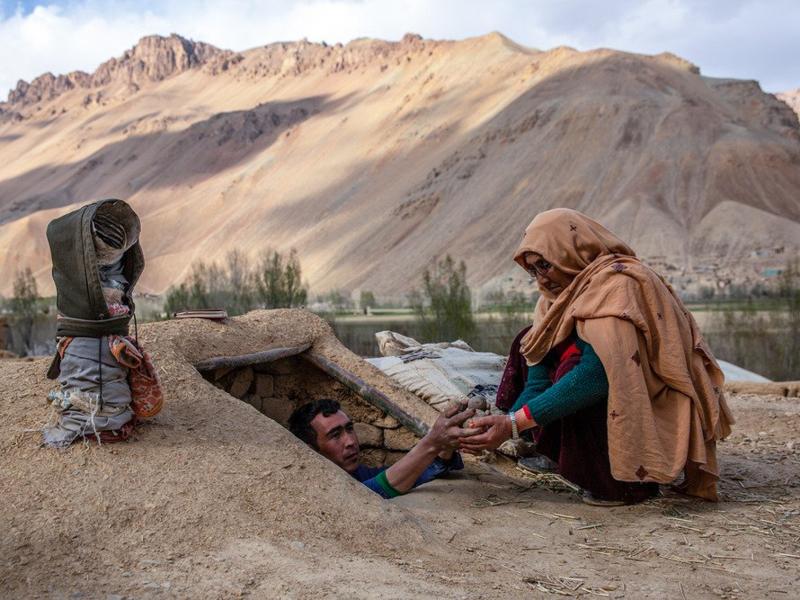 Roqia Qasqari, right, who lives in Gero village in Afghanistan's Bamyan Province, inspects potatoes stored from a previous harvest. Snow was scarce over the winter, raising fears of a severe drought in 2021. Roqia Qasqari, right, who lives in Gero village in Afghanistan's Bamyan Province, inspects potatoes stored from a previous harvest. Snow was scarce over the winter, raising fears of a severe drought in 2021.