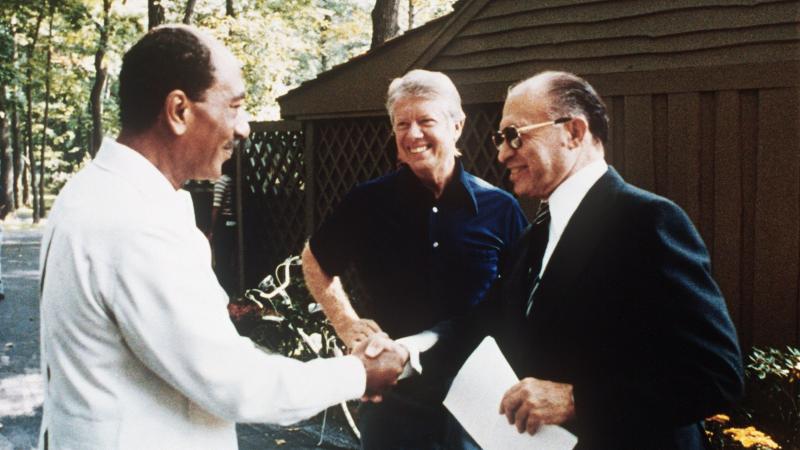 As President Jimmy Carter looks on, Egyptian President Anwar Sadat (left) shakes hands with former Israeli Prime Minister Menachem Begin at Camp David on Sept. 6, 1978. As President Jimmy Carter looks on, Egyptian President Anwar Sadat (left) shakes hands with former Israeli Prime Minister Menachem Begin at Camp David on Sept. 6, 1978.