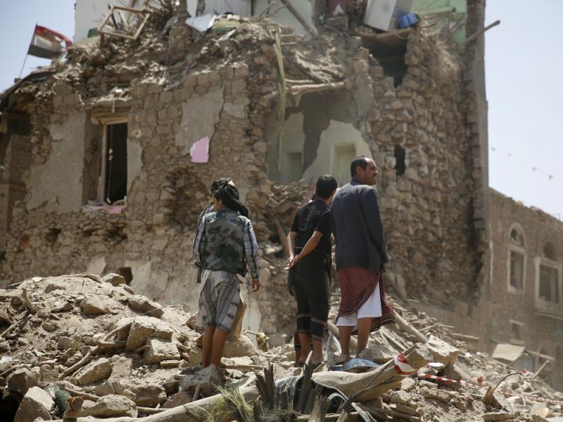 People stand amid the rubble of a house damaged by a Saudi-led airstrike last month in the old city of Sanaa, Yemen's capital. People stand amid the rubble of a house damaged by a Saudi-led airstrike last month in the old city of Sanaa, Yemen's capital.