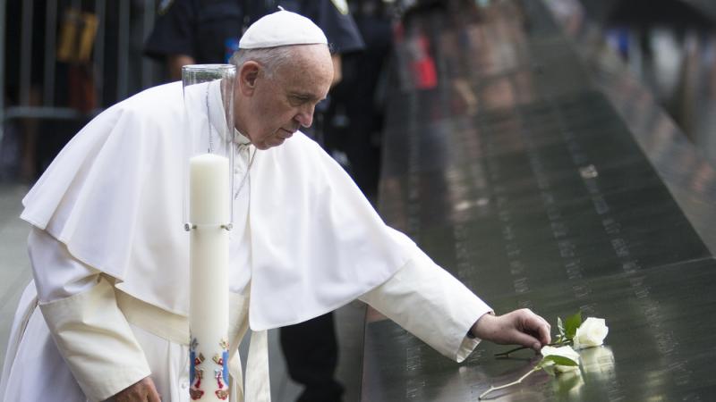 Pope Francis places a white rose at the South Pool of the Sept. 11 memorial in downtown Manhattan on Friday. Pope Francis places a white rose at the South Pool of the Sept. 11 memorial in downtown Manhattan on Friday.