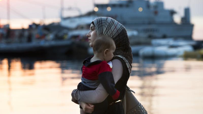 A Syrian refugee woman walks to the ferry Eleftherios Venizelos, which functions as a registration center and accommodation for migrants and refugees on the Greek island of Kos, on Aug. 17. The Islamic State has released multiple videos calling on refugee A Syrian refugee woman walks to the ferry Eleftherios Venizelos, which functions as a registration center and accommodation for migrants and refugees on the Greek island of Kos, on Aug. 17. The Islamic State has released multiple videos calling on refugee