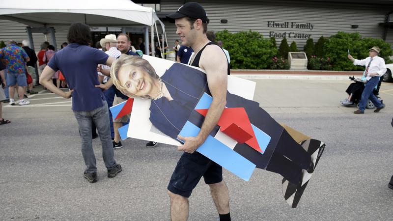 A man carries a cardboard cutout of Hillary Clinton in Des Moines, Iowa. Clinton and other traditional candidates have struggled to breakthrough as outsiders have captured the attention this summer. A man carries a cardboard cutout of Hillary Clinton in Des Moines, Iowa. Clinton and other traditional candidates have struggled to breakthrough as outsiders have captured the attention this summer.