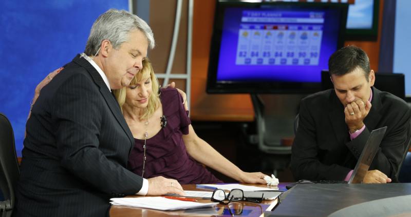 WDBJ-TV news morning anchor Kimberly McBroom gets a hug from visiting anchor Steve Grant as meteorologist Leo Hirsbrunner reflects Thursday after their early morning newscast at the station. WDBJ-TV news morning anchor Kimberly McBroom gets a hug from visiting anchor Steve Grant as meteorologist Leo Hirsbrunner reflects Thursday after their early morning newscast at the station.