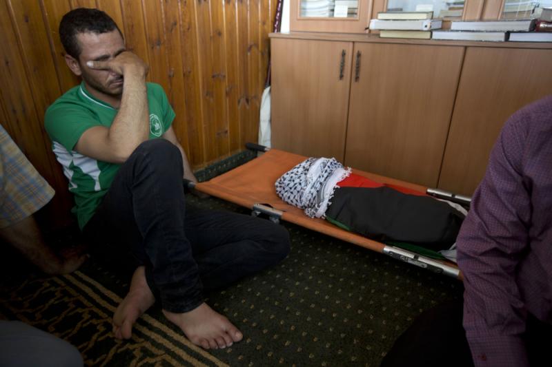 A Palestinian man mourns alongside the body of a one-and-a-half year old boy, Ali Dawabsheh, during his funeral in Duma village near the West Bank city of Nablus on Friday. A Palestinian man mourns alongside the body of a one-and-a-half year old boy, Ali Dawabsheh, during his funeral in Duma village near the West Bank city of Nablus on Friday.