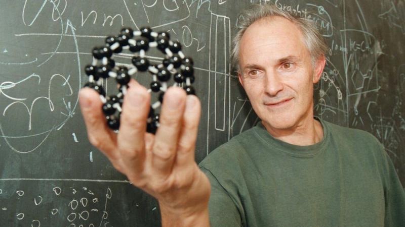 Harry Kroto, pictured in 1996, displays a model of the geodesic-shaped carbon molecules that he helped discover. Harry Kroto, pictured in 1996, displays a model of the geodesic-shaped carbon molecules that he helped discover.