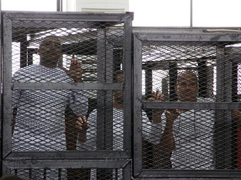 Al-Jazeera English journalists Mohammed Fahmy, left, Baher Mohamed, center, and Peter Greste, right, appeared in a cage during their trial on terrorism-related charges in Cairo in March 2014. The journalists denied all charges. Greste, an Australian, was Al-Jazeera English journalists Mohammed Fahmy, left, Baher Mohamed, center, and Peter Greste, right, appeared in a cage during their trial on terrorism-related charges in Cairo in March 2014. The journalists denied all charges. Greste, an Australian, was