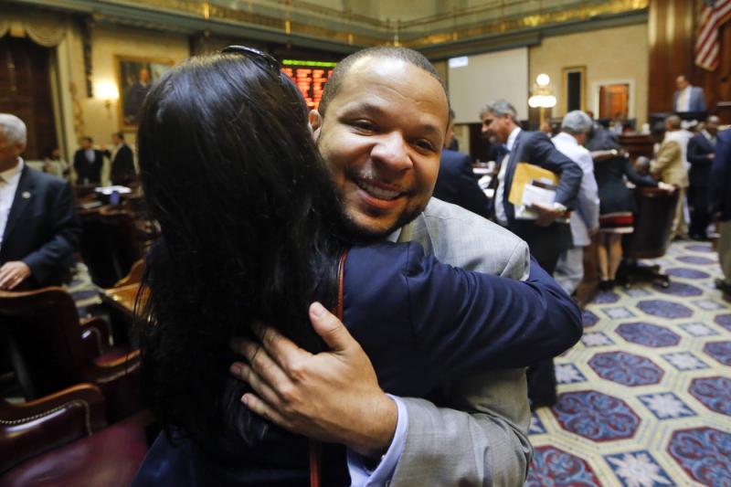 State Rep. John King, D-York, hugs a woman after the House approved a bill removing the Confederate flag from the Capitol grounds early Thursday in Columbia, S.C. State Rep. John King, D-York, hugs a woman after the House approved a bill removing the Confederate flag from the Capitol grounds early Thursday in Columbia, S.C.