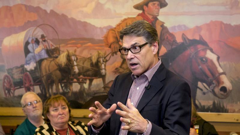 Former Texas Gov. Rick Perry, sporting black-rim glasses, speaks at a Pizza Ranch in Sioux Center, Iowa, last week. Former Texas Gov. Rick Perry, sporting black-rim glasses, speaks at a Pizza Ranch in Sioux Center, Iowa, last week.
