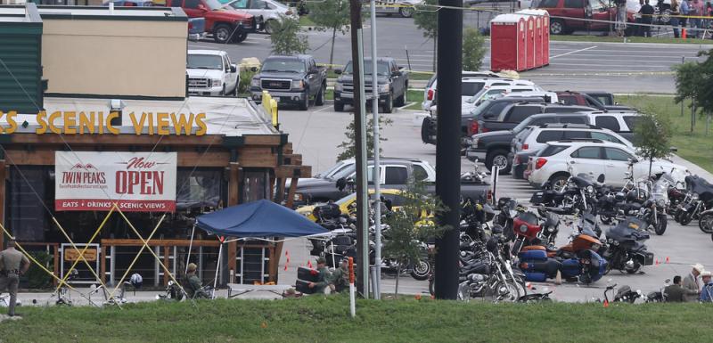 Police officers observe the scene at Twin Peaks restaurant in Waco, Texas, the site of the recent motorcycle gang-related shooting. Police officers observe the scene at Twin Peaks restaurant in Waco, Texas, the site of the recent motorcycle gang-related shooting.