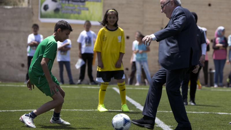 FIFA President Sepp Blatter kicks a ball during the inauguration of a football stadium in the village of Dura al-Qari near the West Bank city of Ramallah on Wednesday. Blatter said he is on a FIFA President Sepp Blatter kicks a ball during the inauguration of a football stadium in the village of Dura al-Qari near the West Bank city of Ramallah on Wednesday. Blatter said he is on a
