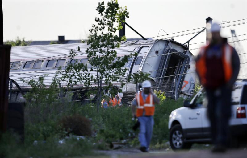Emergency personnel walk near the scene of a deadly train wreck on Wednesday in Philadelphia. Emergency personnel walk near the scene of a deadly train wreck on Wednesday in Philadelphia.