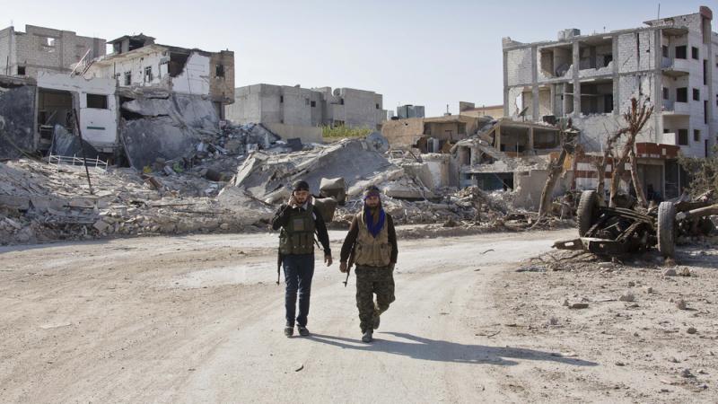 Kurdish rebels in northern Syria walk near the devastated town of Kobani last November. In a global report card on international cooperation, the failure to halt civil wars, like the one in Syria, was cited as the biggest shortcoming. Kurdish rebels in northern Syria walk near the devastated town of Kobani last November. In a global report card on international cooperation, the failure to halt civil wars, like the one in Syria, was cited as the biggest shortcoming.